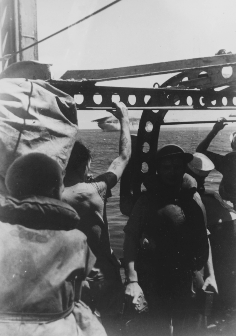 Crewmen from a destroyer watch as the Langley is scuttled and sinking, on February 27th while part of convoy MS-5. She was attempting to reach https://en.m.wikipedia.org/wiki/Cilacap_Regency with a load of P-40 fighters to the island of Java in the Dutch East Indies. Dead in the water after being bracketed by Japanese Betty Bombers she couldn’t make it into the harbor and was scuttled by destroyers using four inch guns and two torpedos, too prevent her from falling into enemy hands. Many of the sailors rescued were subsequently killed when the ship they were evacuated was sunk later that day.